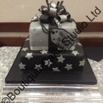 Black and silver present themed stacked cake with stars