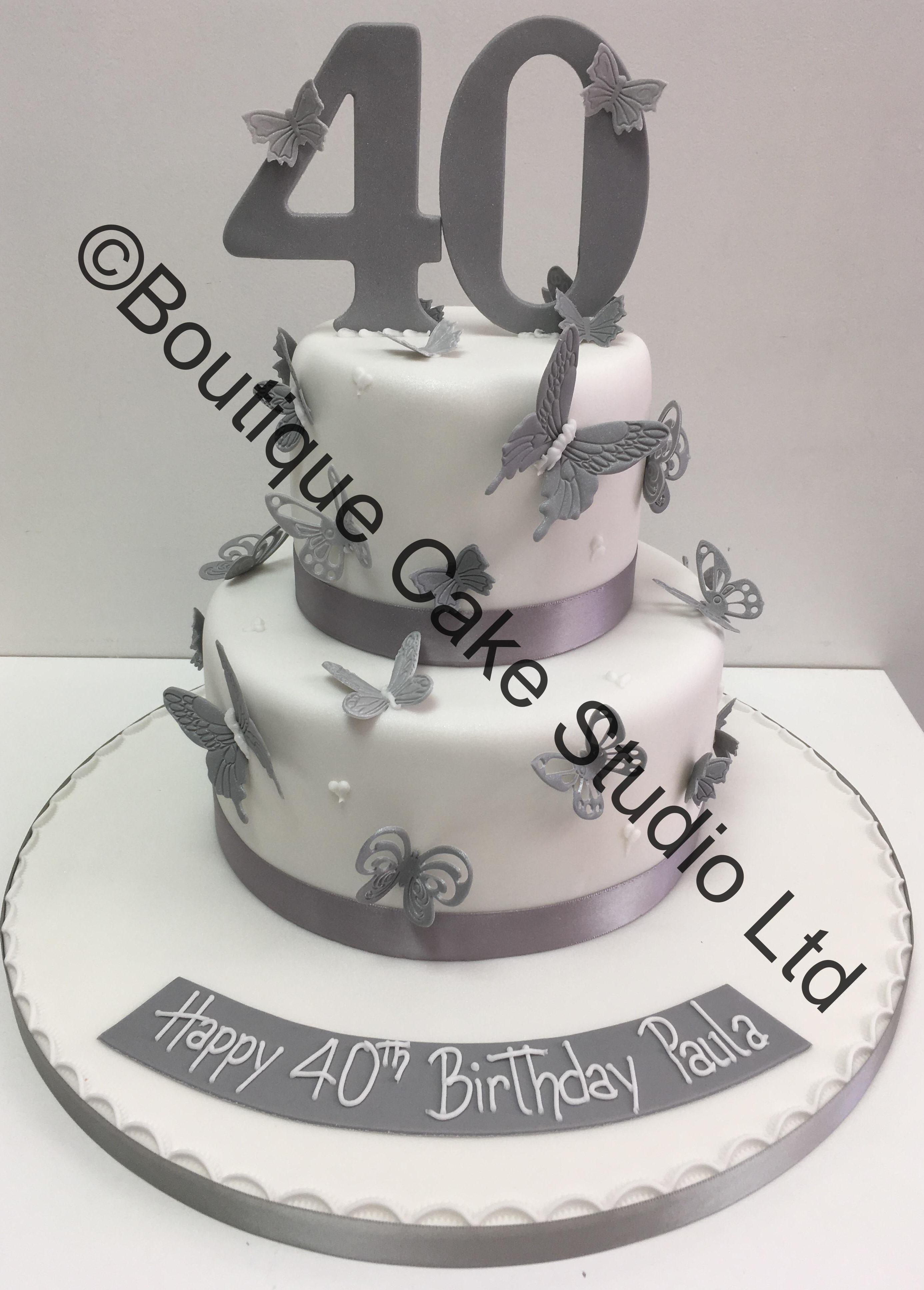 Silver and white butterfly themed stacked cake