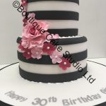 Black and White striped stacked cake with pink flowers