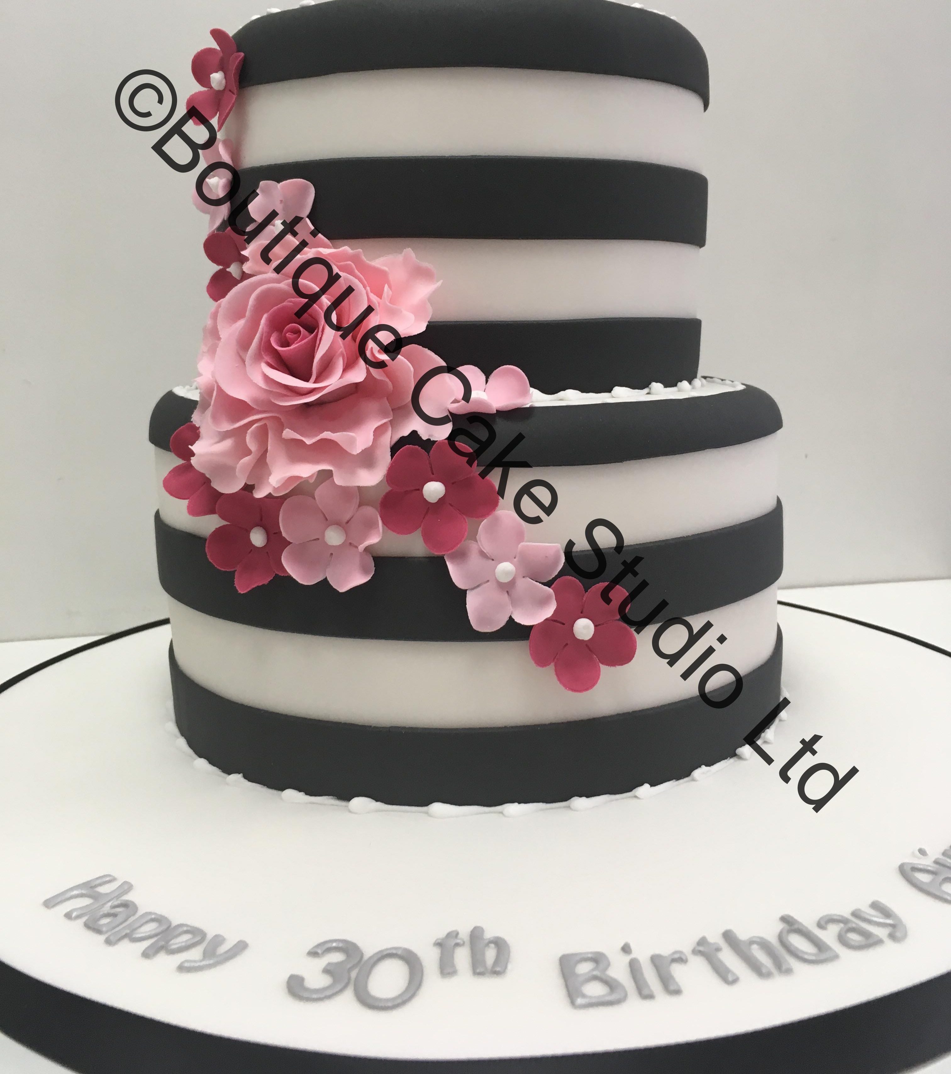 Black and White striped stacked cake with pink flowers