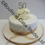 Golden Wedding Cake with flowers and Trellis